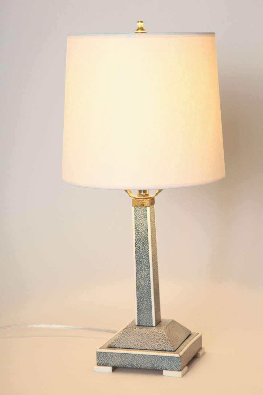 With square tiered shagreen base and shagreen shaft.
Rewired for American standard and in good working condition.
New silk shade.
Base – 8 3/8” high; base – 4 3/8” square; total height with shade – 16 ½”.

(Price shown is reduced price, no further