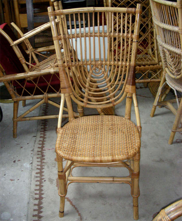 French Riviera vintage 1950s set of two armchairs and four chairs in rattan.