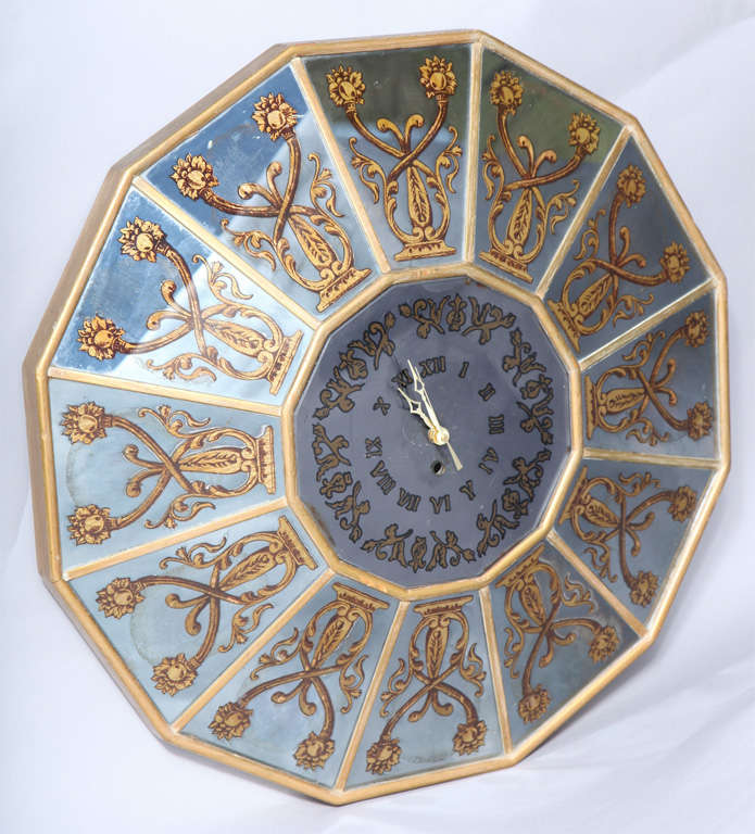 Wall clock, having a gilded wooden frame inset with twelve reverse painted painted mirrored tiles, of scrolling classical motifs.