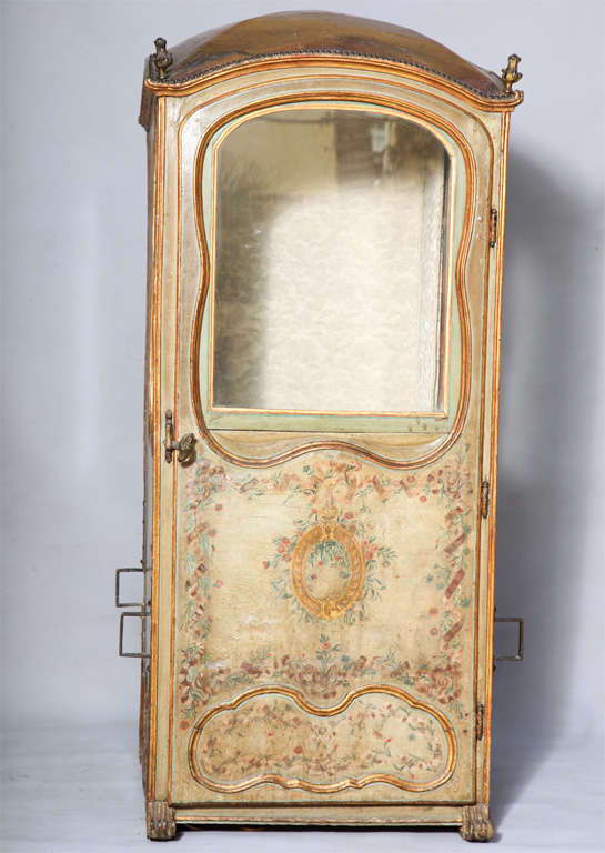 A rare and unusual sedan chair, its side panels and door covered in leather and free-form mullions decorated by hand-painted florals, domed roof with a gilded finial at each corner.  It's interior now fitted with a makeshift table and mirror top so