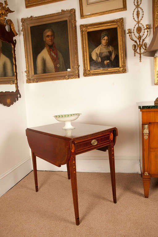 This beautiful Pembroke Table has bellflower, segmented oval and string inlay - one drawer with a dummy on the opposite side - unusual canted corners on leaves - new French polish - replaced Hepplewhite pulls.