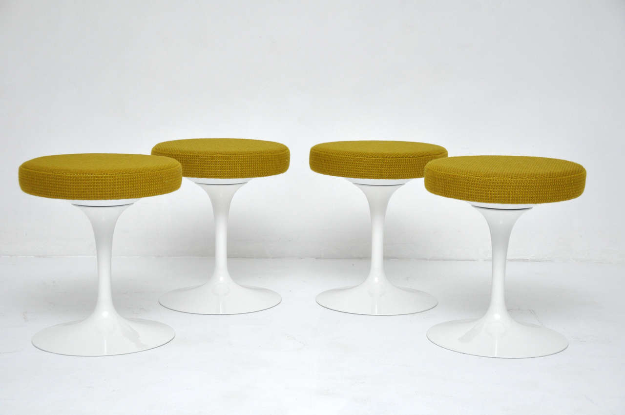 Set of four swivel stools designed by Eero Saarinen for Knoll. Newly upholstered in green Knoll Cato fabric.