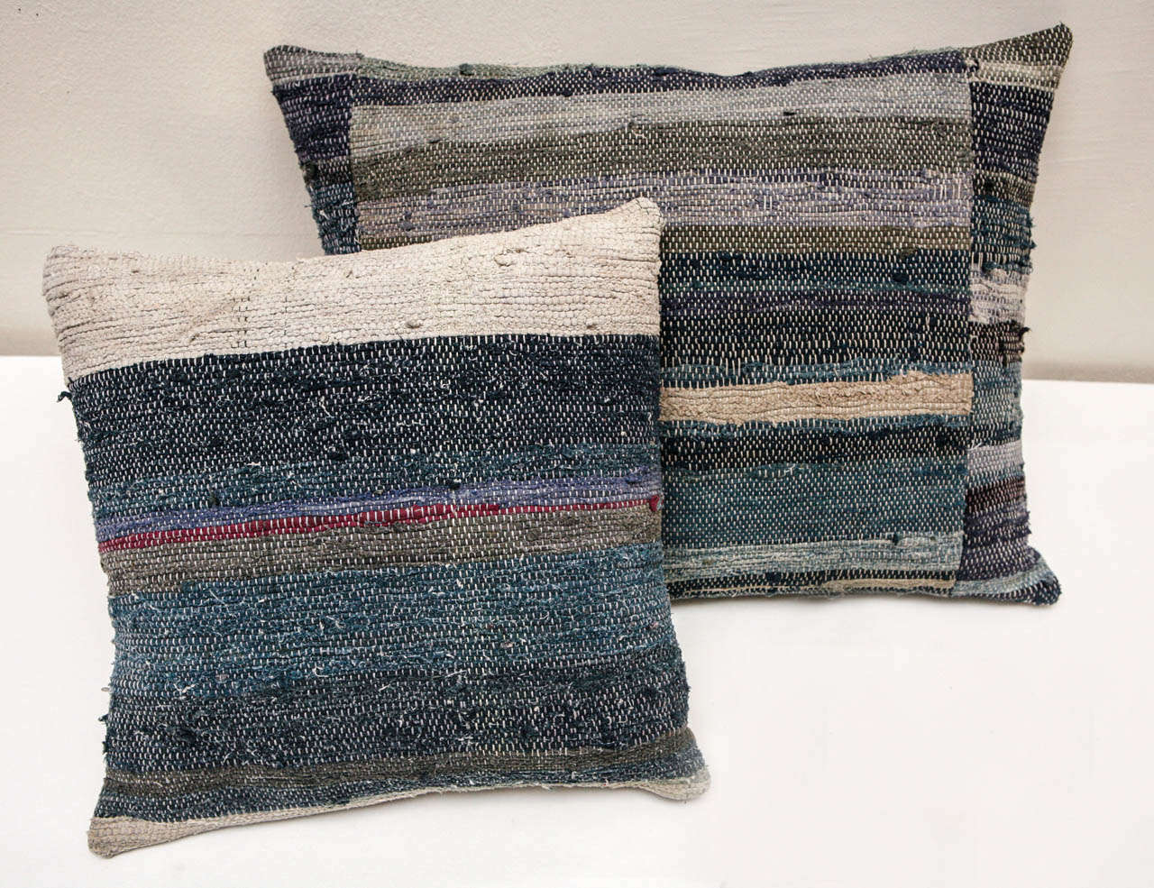 Various pillows made from various shades of indigo, ivory, red, gray and purple Chinese Hmong rag rug. Taupe linen backs. Hidden zipper enclosure, feather & down fill. Priced individually. 

15