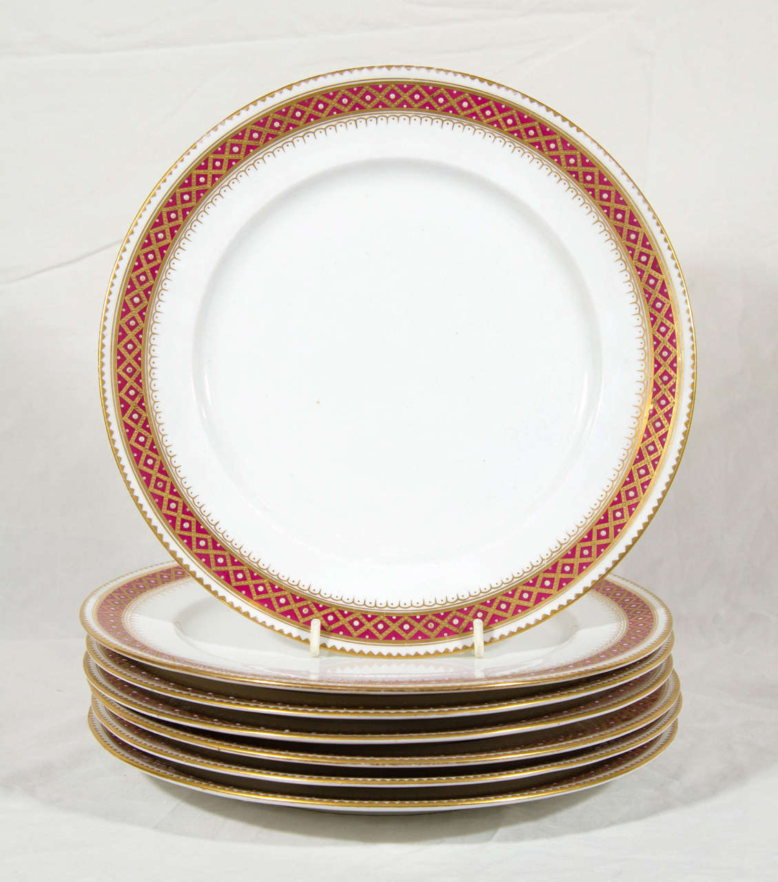 A set of a dozen 19th century Copeland dinner dishes with a red and gold jeweled border.