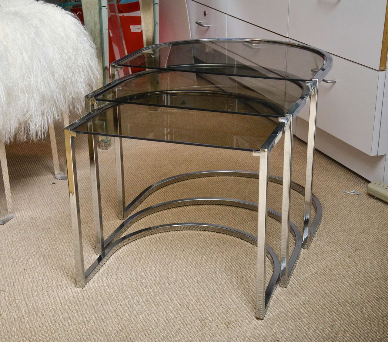 Attractive set of three Mid-Century glass and chrome nesting tables by Milo Baughman.