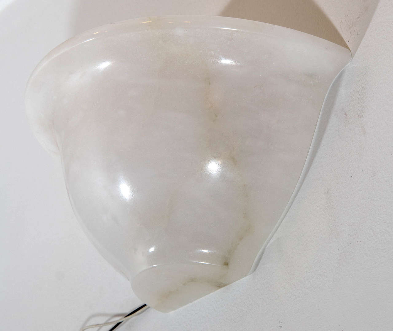Carved from a single piece of creamy white alabaster, the lightly veined sconce has been rewired with UL parts and holds one or two 60 watt equivalent LED bulbs.