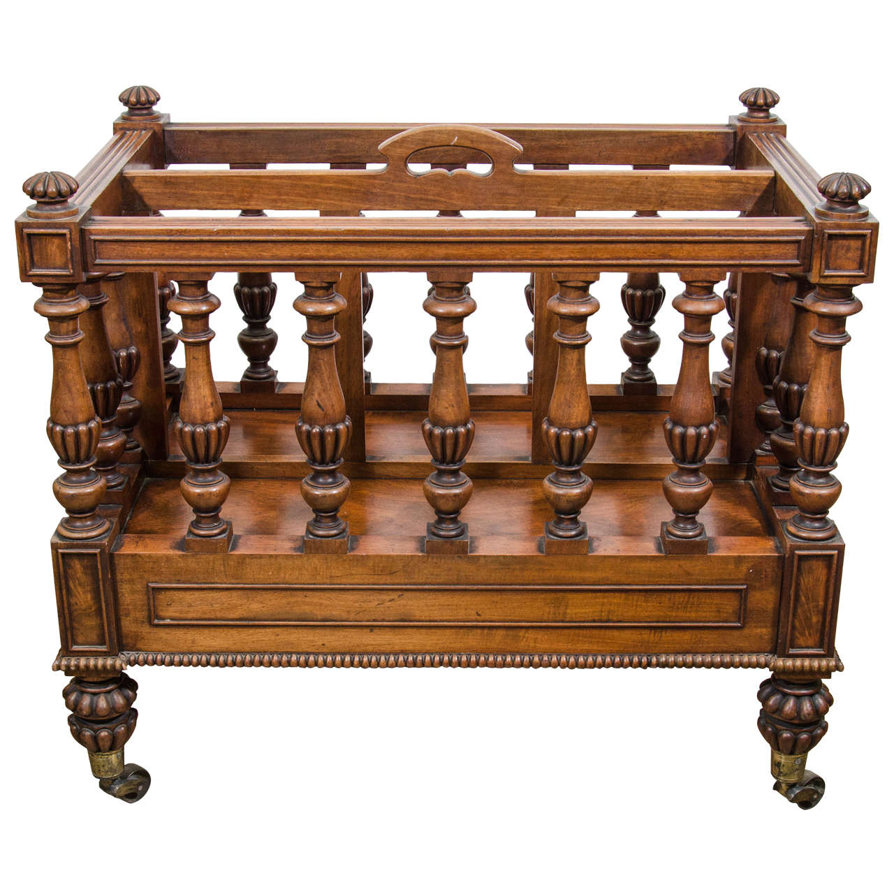 Bold William IV carved mahogany Canterbury with reeded moldings, part-reeded baluster spindles, single drawer and pierced handle.