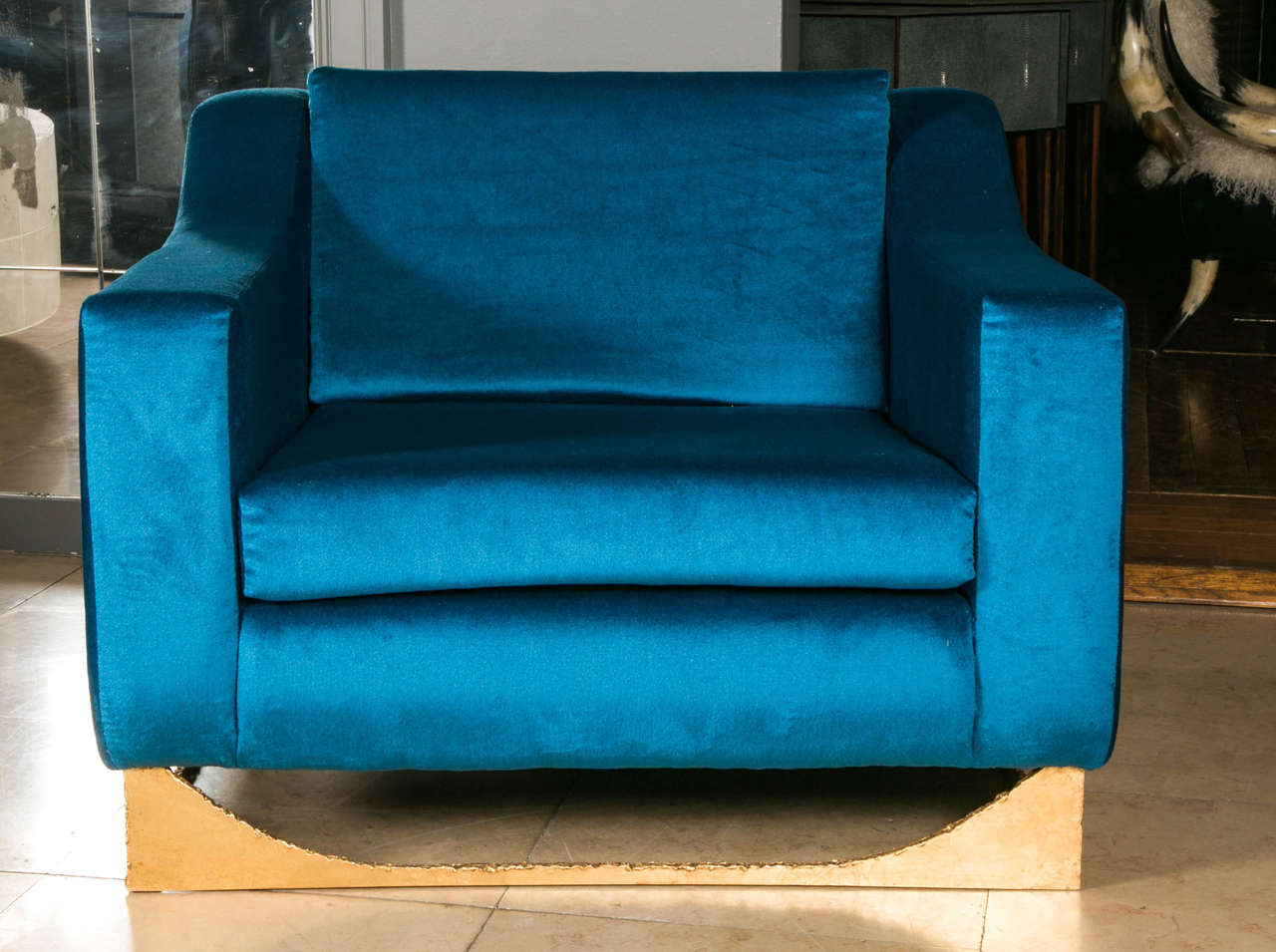 Pair of armchairs with a gilt bronze basement, upholstered with blue fabric.