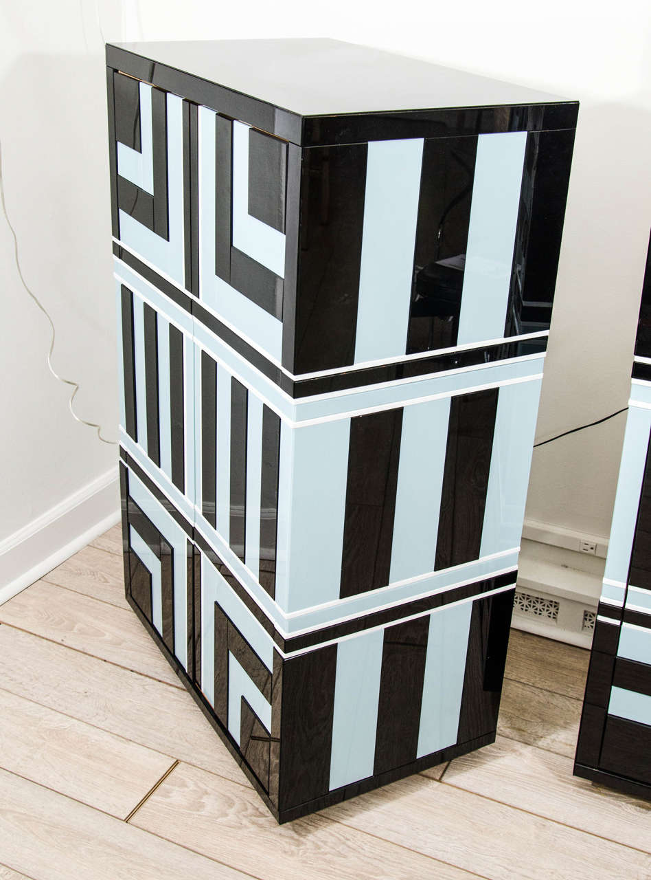 Pair of tall cabinets featuring black and pale blue opaline glass geometric design.