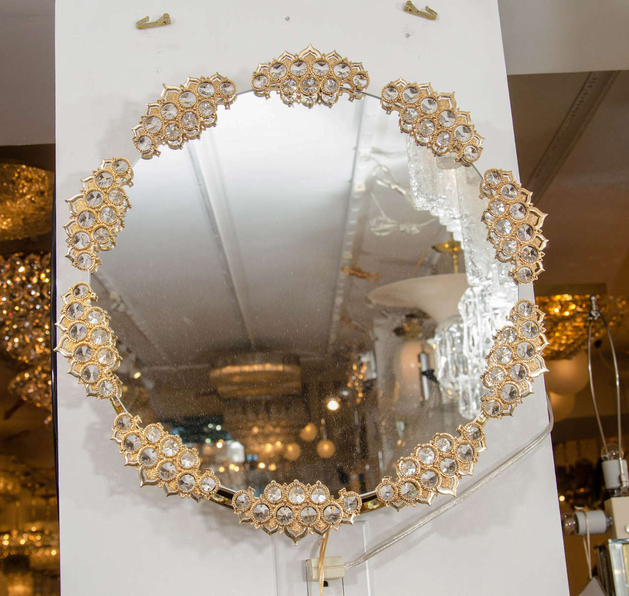 Round, back-lit mirror with clustered, gilt metal, 