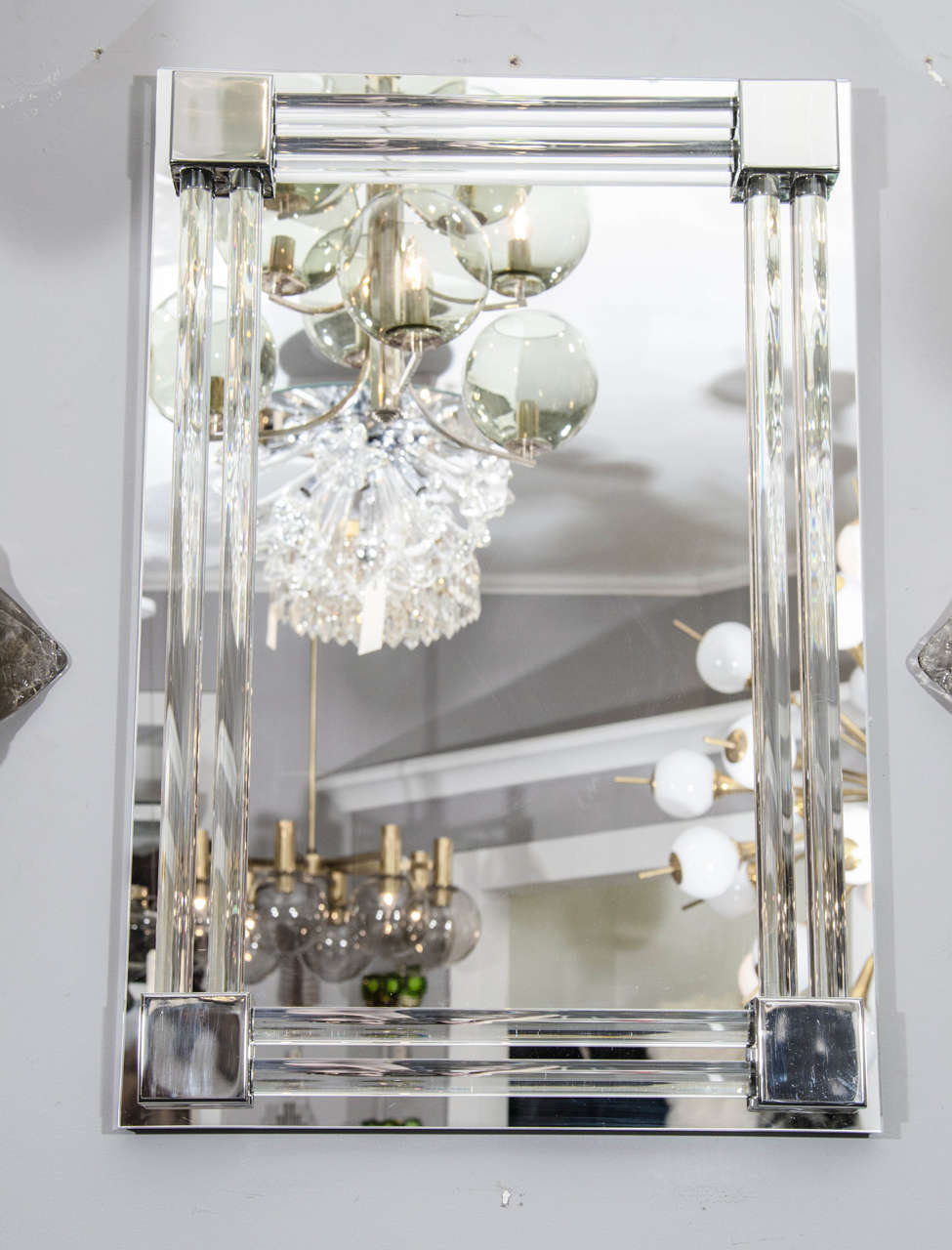 Made to order and customized to your specifications this stylish and chic mirror is framed in polished nickel with raised corner details connecting a surrounding double row of solid glass rods. 

Material and finish options are available. Please