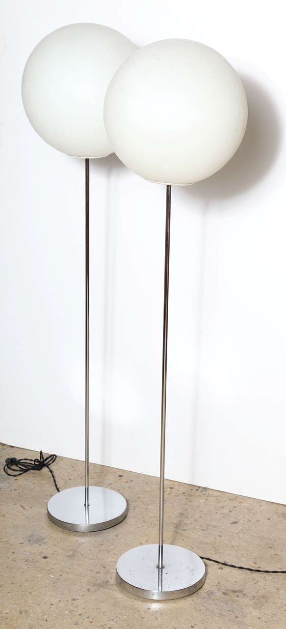 Pair of American midcentury, Neal small floor lamps. Featuring spherical, translucent white frost plastic polypropylene orbs, tubular chrome columns and round weighted chrome bases. Original condition. Pop Art. Minimalist. Statement lighting.