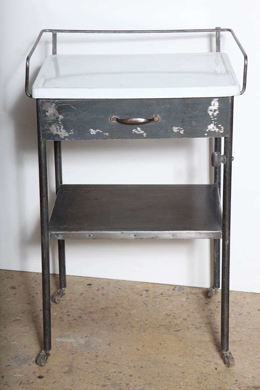 Steel Night Stand, End or Side Table with drawer and shelf complete with White Enamel top.  Nice towel rack detail. Great multi use piece with good storage for compact, small space.  Could work nicely in Bathroom, Office, Study or Library.  Restored