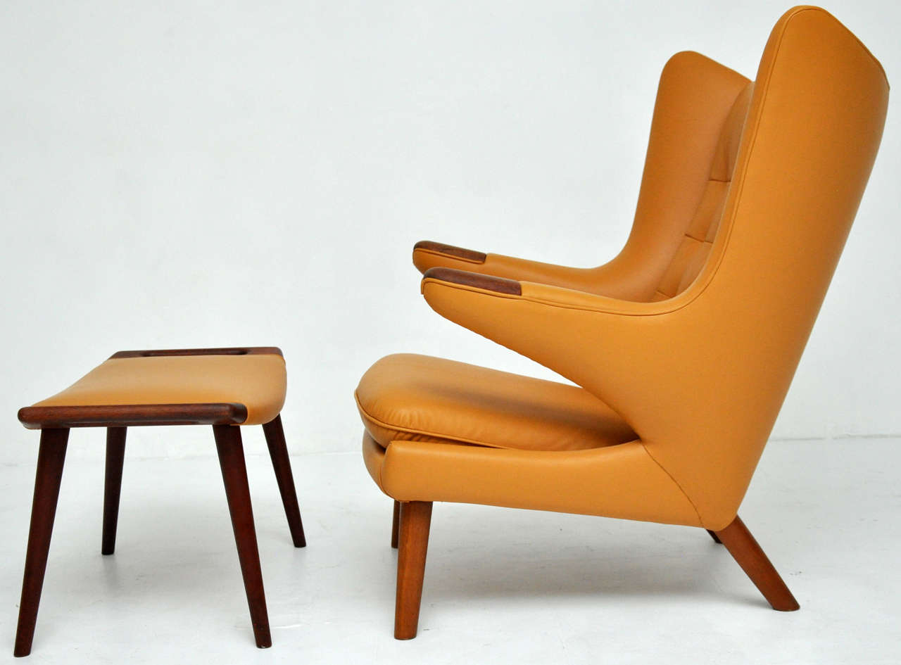 Papa Bear chair and ottoman buy Hans Wegner.  Teak paws and legs.  Newly upholstered in butterscotch leather.