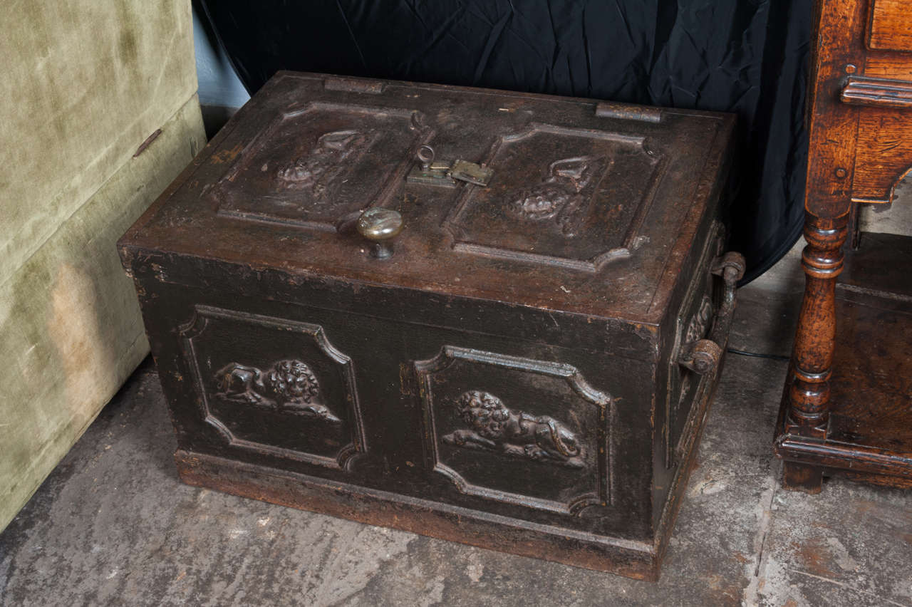 Iron strong box with lion mounts.