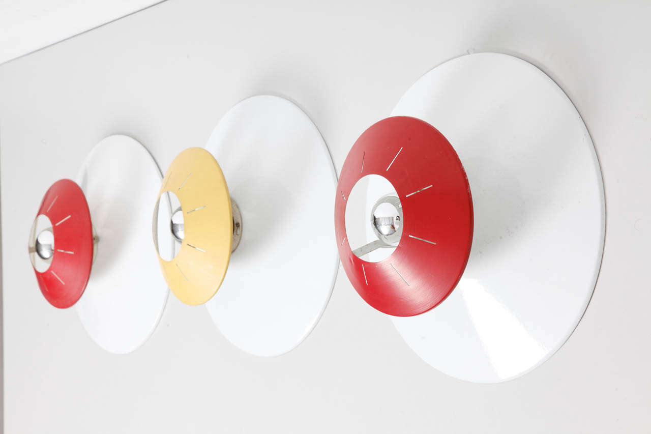 Set of 9 Wall lights designed by Philips.
Enamaled Metal frames,white red,white yellow.