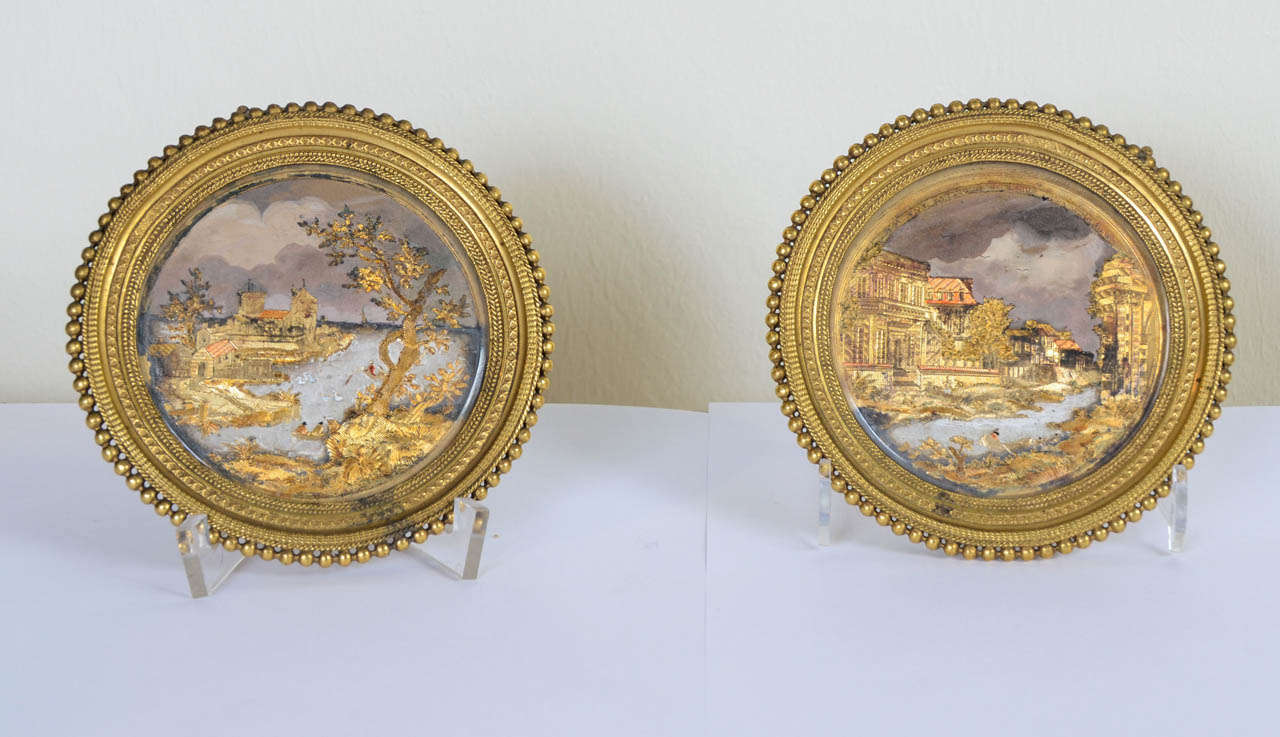 Pair of medallions attributed to Compigne. Privileged tabletier of King Louis XV. Representing lake-side landscape with rivers, antique ruins, palaces and vegetation with figures. One of the two is titled 'Vue des environs de Rome faite sur le