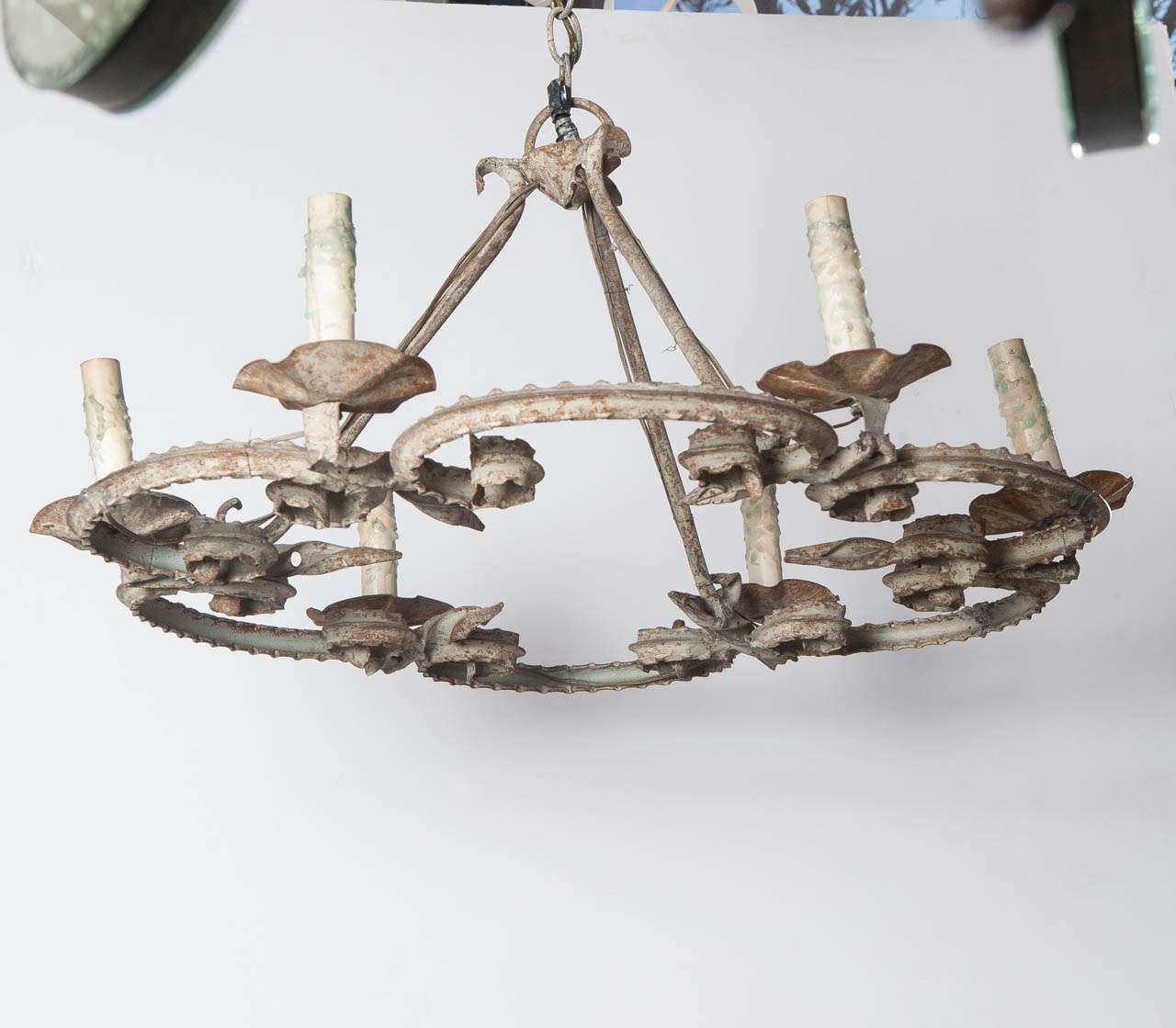 Iron chandelier has 6 arms.  Rustic painted finish.  Electrified.