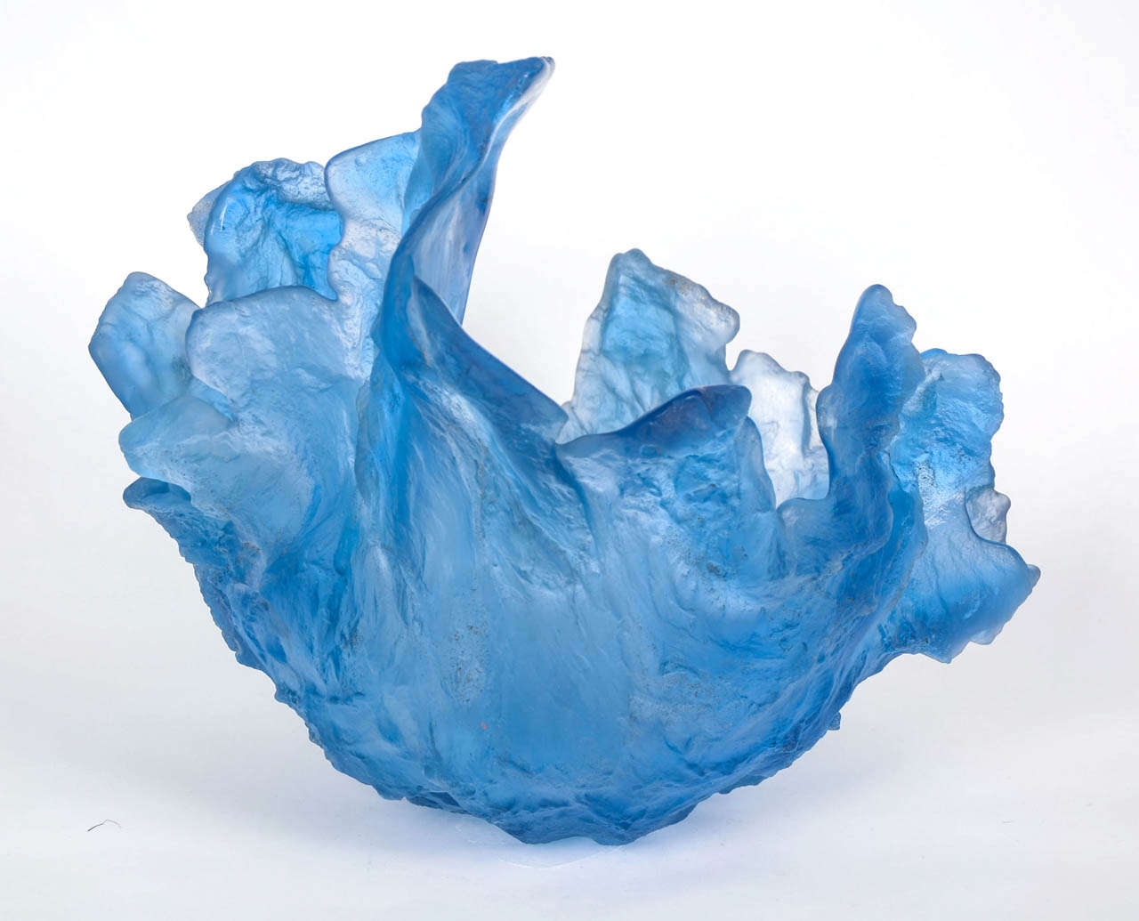 Sculptural sand cast centrepiece by Amanda Brisbane. 
 
Brisbane is a true alchemist, mixing all of her own colours she exploits the spontaneous and organic technique using sand as a manipulable mould to make detailed, delicate glass forms with