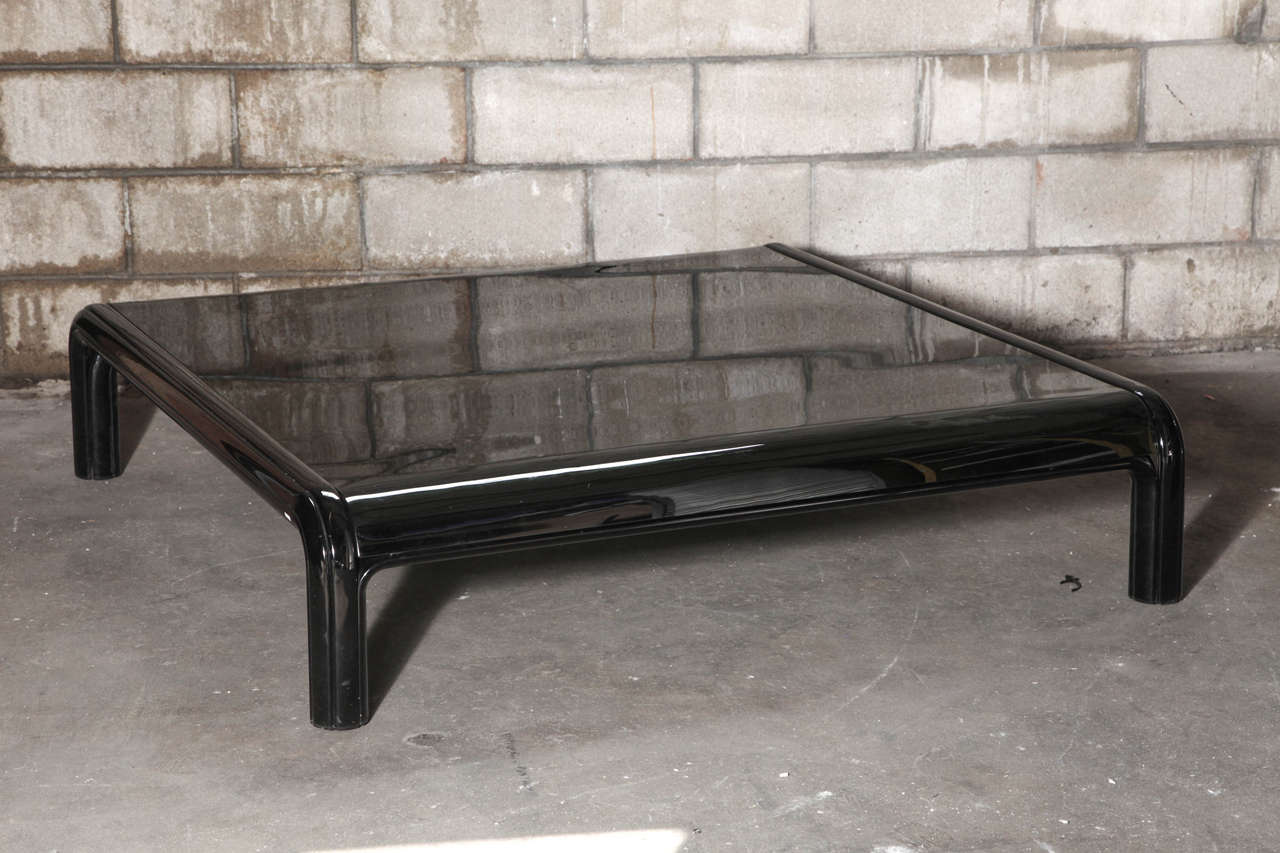 Large, low table in black enameled steel with smoked glass top. From the 1976 Aulenti Collection for Knoll.