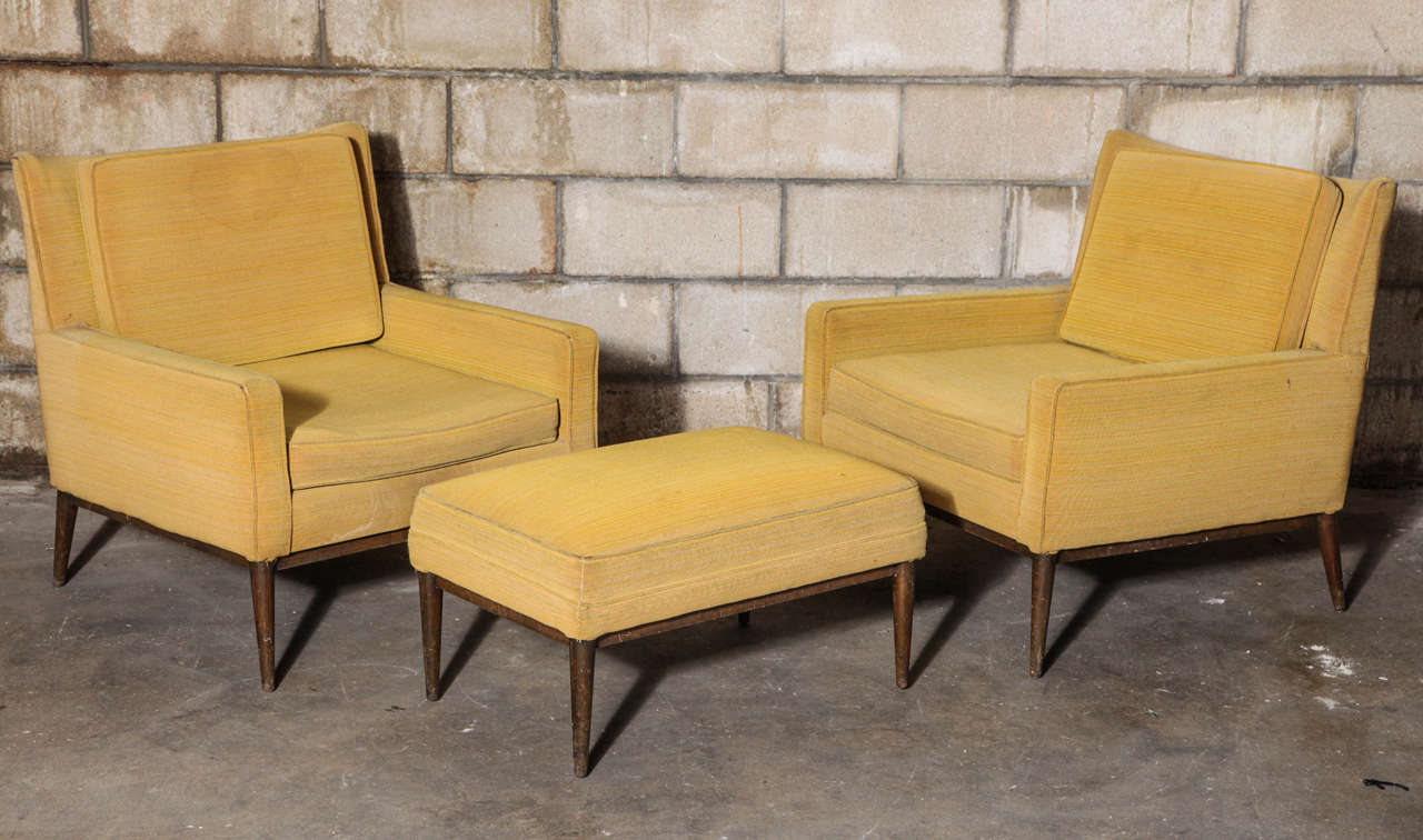 Handsome, low-slung club chairs with matching ottoman in original upholstery. Model 302 by Paul Mccobb for Directional.