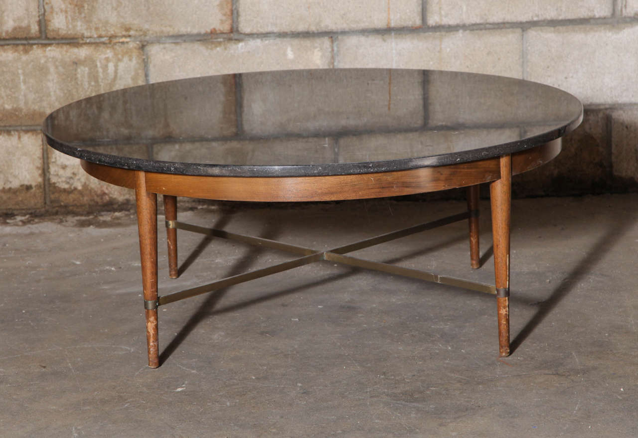Beautiful black marble coffee table with brass stretchers by Paul McCobb.