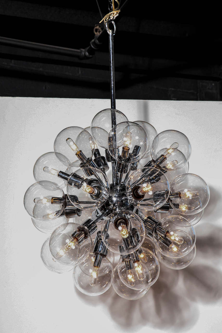 Motoko Ishii for Staff Leuchten Chrome Hanging Lamp with 28 Clear Glass Globes. Featuring a Chrome sputnik form with twenty eight original clear glass shades with twenty eight interior filament candelabra bulbs. With adjustable dimmer switch.