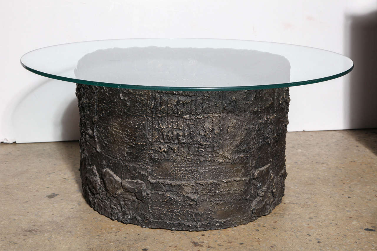 Brutalist Paul Evans Sculpted Metal Collection PE-101 Bronze Resin Coffee Table, circa 1970. Produced exclusively for Directional. Cylindrical sculpted Bronze base measures (3.5-4 D x 24 W). Shown with round (36D x 1/2 H) glass surface.  As seen in