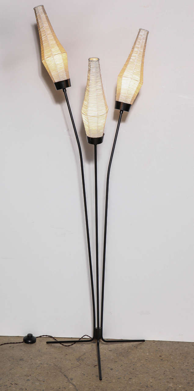 Jean Royère style three stem black iron botanical floor lamp with three white silk bud shades. Featuring three black lacquered branch like metal stems with three, artisan created, bud like white silk thread shades. Shades measure 14 H x 4 W.  On
