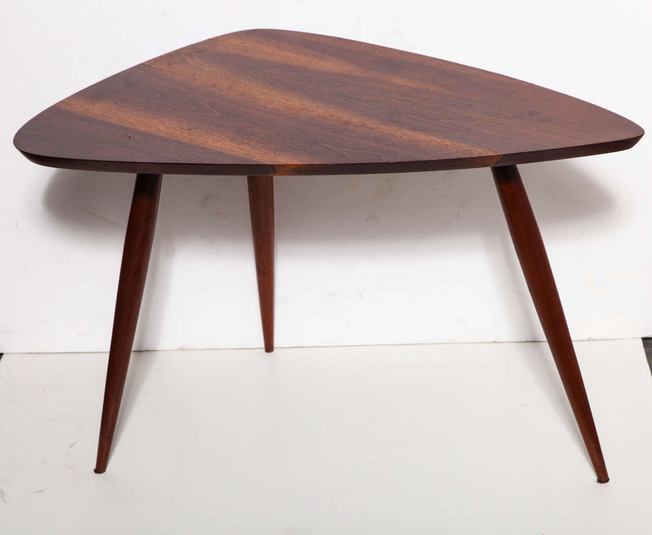 Sculpted triangular Side Table, Coffee Table by Phillip Lloyd Powell, early 1960's. Featuring a guitar pick form in beautifully grained Black Walnut on sturdy tapered tripod legs. Classic. Compact. Lightweight. 
 