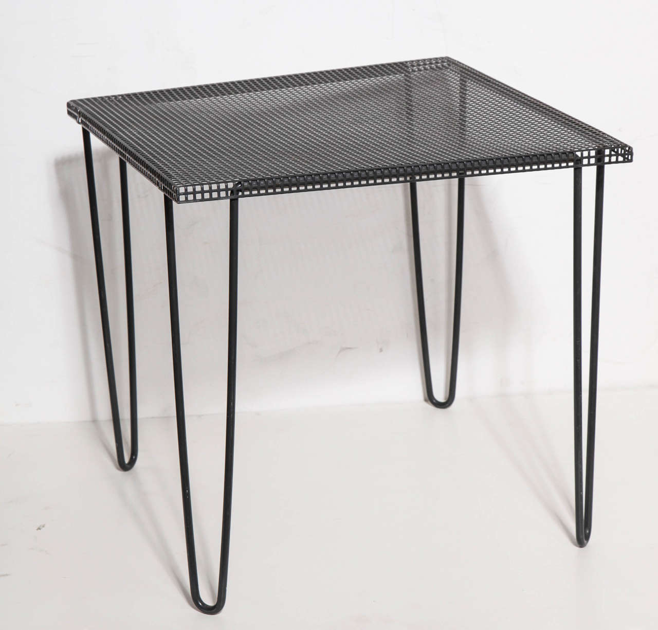 Pair of 1950s Mathieu Matégot style Black enameled Iron and Metal Mesh Tables.  Featuring perforated, square Black Mesh Tops and Black enameled Iron hair pin legs. Versatile. Lightweight. Portable. Sturdy. Atomic, Great Tables for small space. Legs