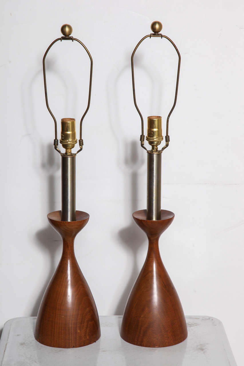 Pair of Walnut & Brushed Steel Reading Table Lamps in the manner of Adrian Pearsall, 1950's. Featuring smooth solid turned Walnut hourglass form with Brushed Steel neck. Architectural. American Craft Movement. Rarity. Made in the USA. 