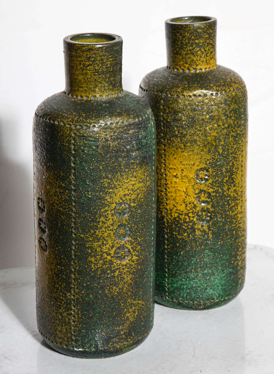 Pair of Italian Modern Aldo Londi for Bitossi Glazed Ceramic Vases. Featuring 
a bottle form hand incised with vertical dot detailing. Earthen. Deep Brown, Dark Green, Forest Green, Leaf Green, Olive Green coloration with Mustard Yellow splash