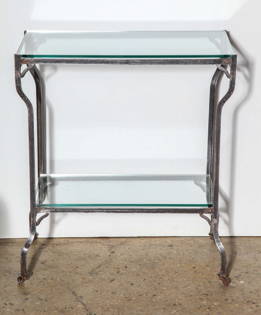 Late 19th Century American Industrial Rolling Dry Bar, Serving Cart with glass shelves. Featuring a steel framework with steel rod and steel bracket detail, two new 3/8 glass shelves, larger top glass shelf, cabriole legs on casters. 20H space