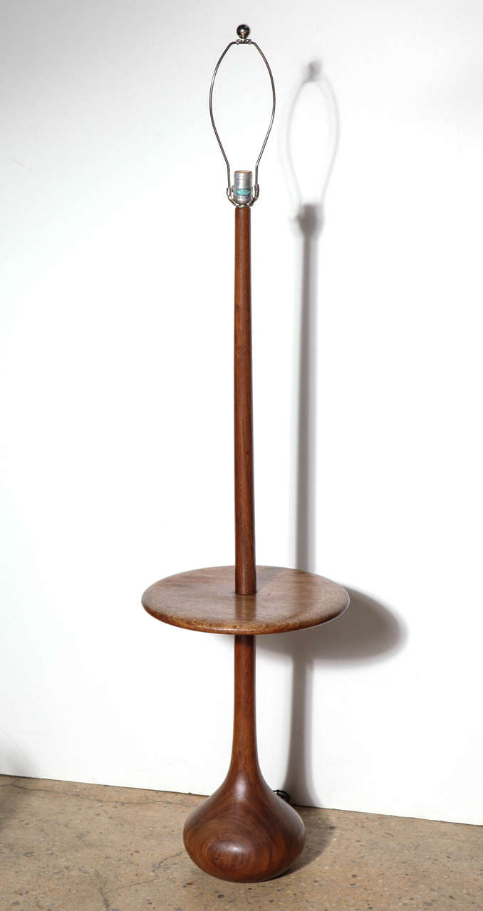 Scandinavian Modern solid Teak combination Side Table Floor Lamp.  
Featuring solid Teak organic construction with elliptical base and sizable 15.5