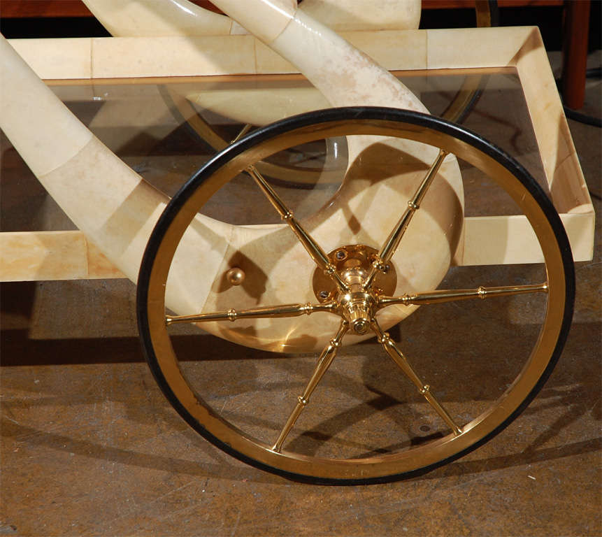 This is one of the most elegant carts ever designed by Aldo Tura, with the swan motif as handles and goatskin workmanship.