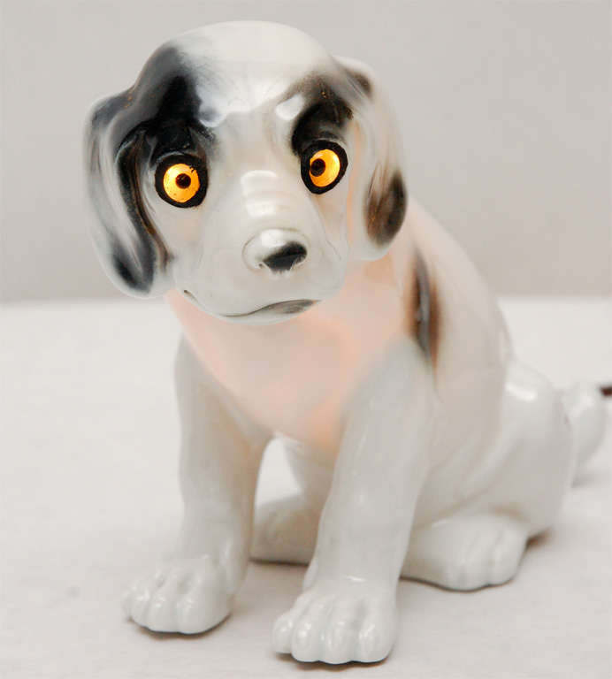 Whimsical white spotted porcelain dog nightlight with glass eyes.