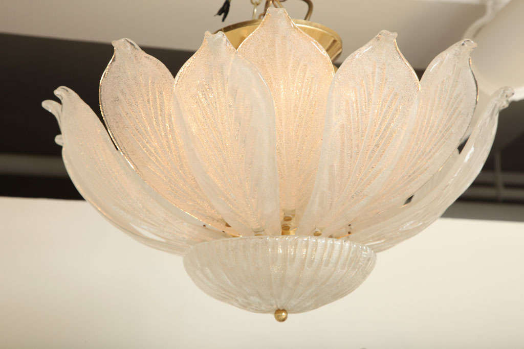 Flawless and elegant, original 1930s Murano chandelier or plafonnier featuring 16 individual leaves sprouting from a central basin, gorgeous texture with brass details and frame.  This style of crystal glass is called 