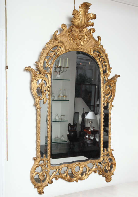 Late 18th century giltwood Regence mirror, finely sculptured pediment, decorated foliage leaves and flowers.