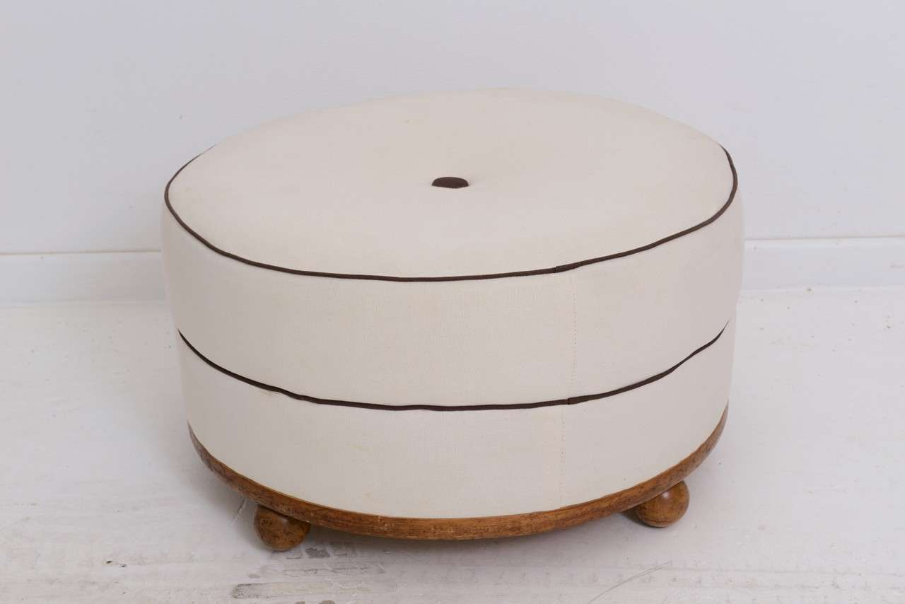 Round Art Deco ottoman with wood trim and four ball legs.

Please feel free to contact us directly for a shipping quote or any additional information by clicking 