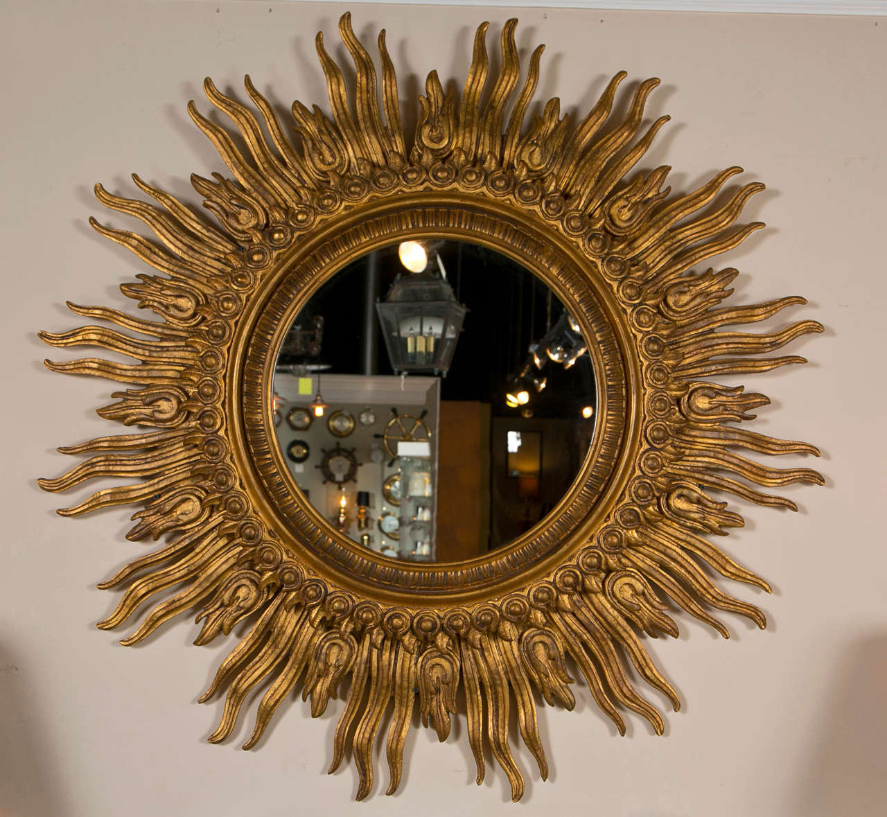 Decoratively Carved gilded wood Sunburst mirror.  