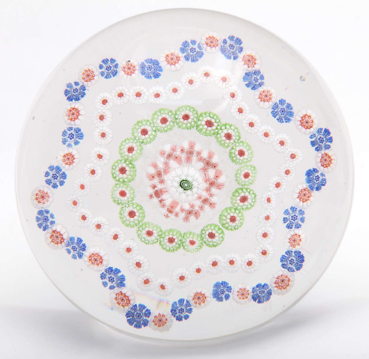 A rare antique Baccarat piedouche paperweight with a hexagon pattern millefiori design on top and blue and white torsade at the base
