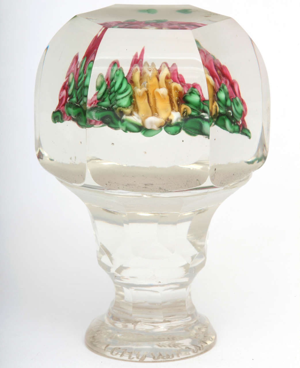 A rare Russian glass paperweight seal with two red flowers and one yellow flower on top and engraving on the bottom