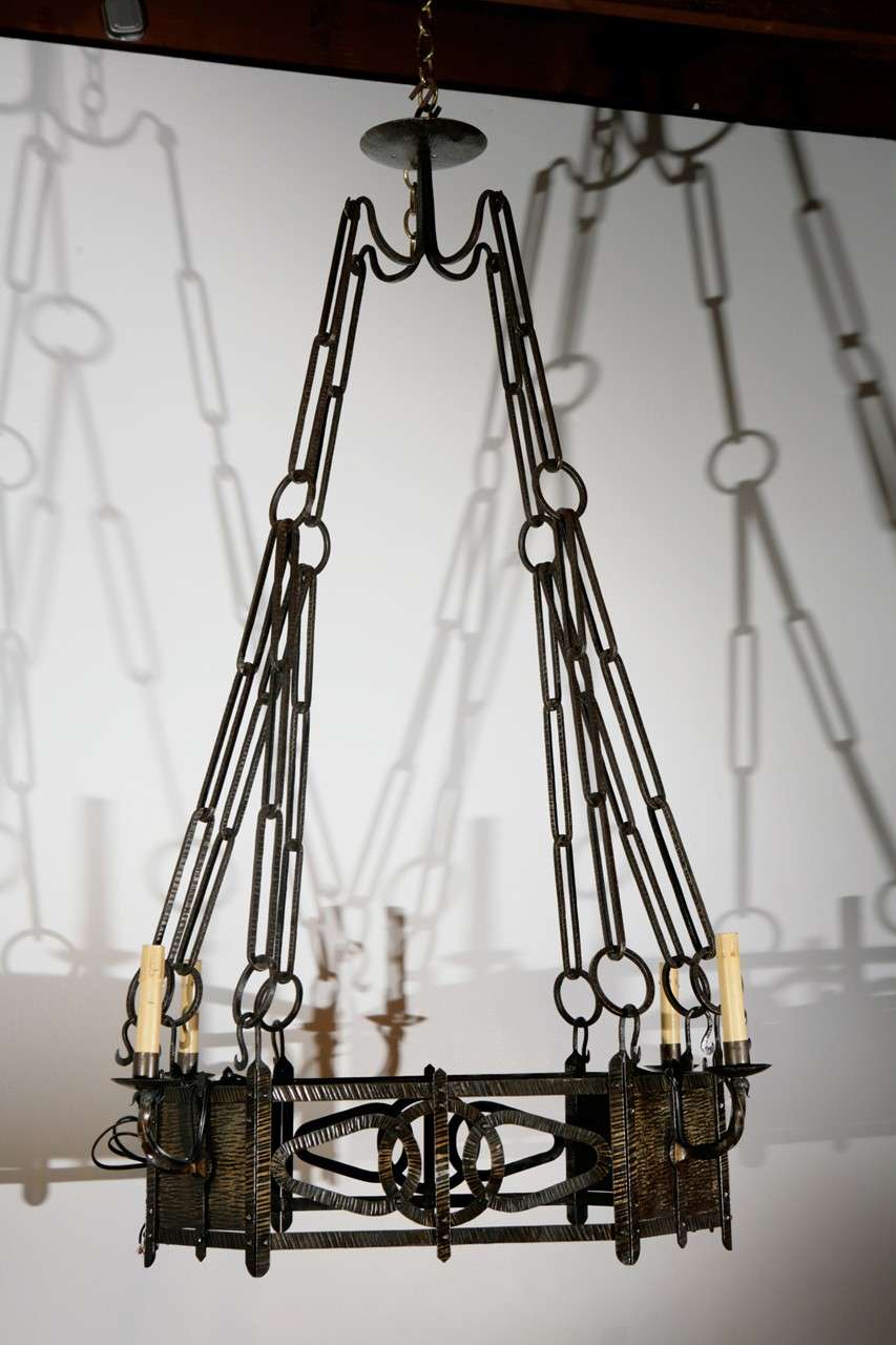 Finely hammered brass chandelier with four lights.