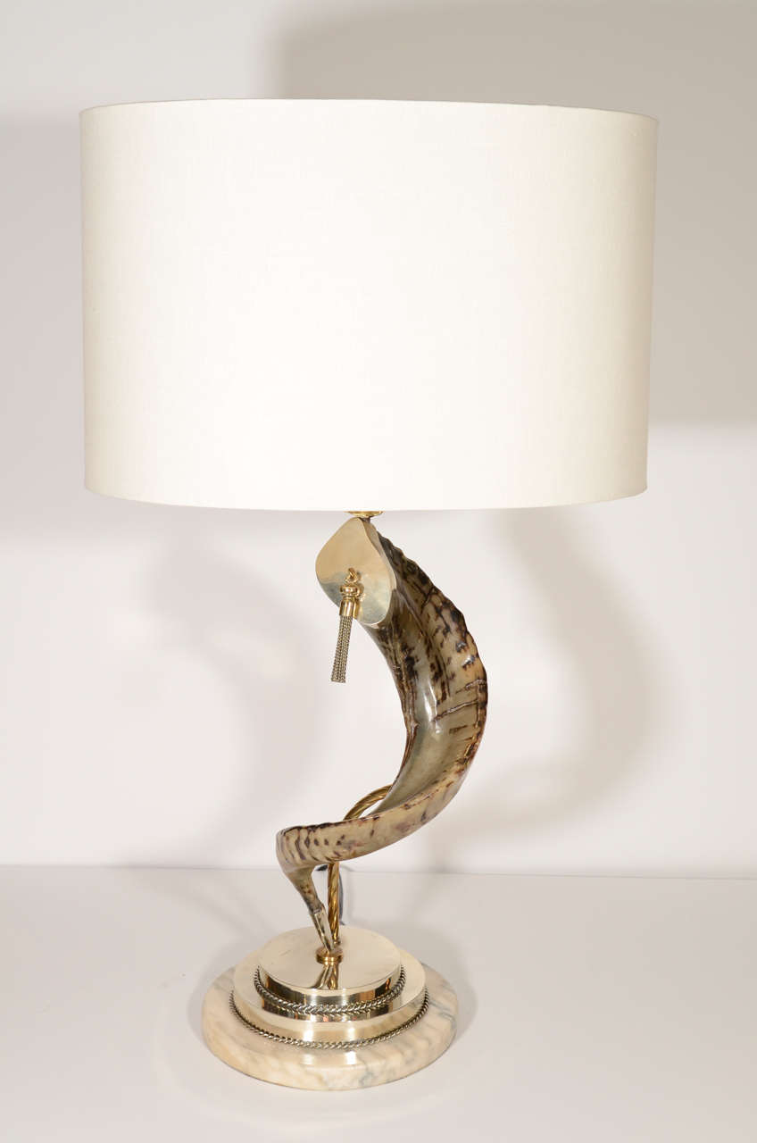 Pair of large single ram horn lamps with stepped bases in exotic marble and nickle with roped details.  The curved horn is held by a stylized brass stem and has brass and silvered fittings with tassle detail. Newly electrified and shown with custom