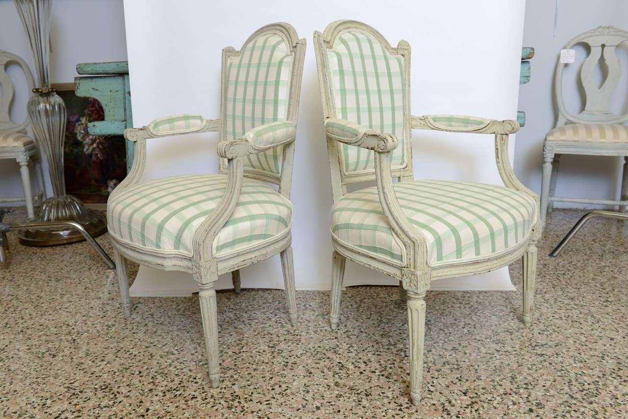 Antique pair of beautifully carved Swedish armchairs. 
Circa 1800. Unknown Stockholm maker. Refreshed with layers of original paint; reupholstered.

D: 19
