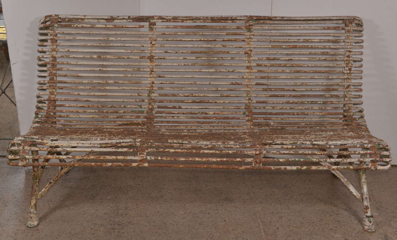 French iron bench by Arras.
Charming chipped paint with 
manufactuer's tag