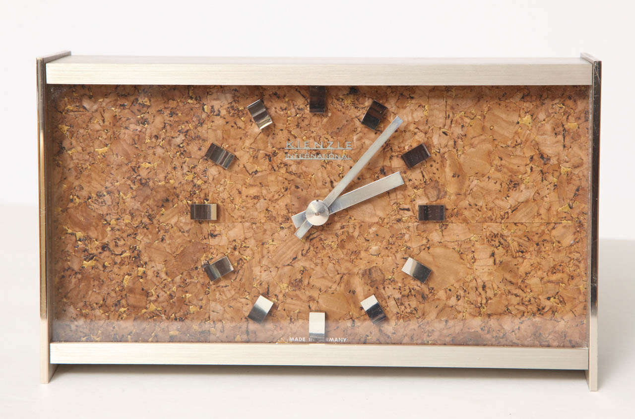 Decorative desk clock. Face is made of cork and the outer shell is metal.
Made by Kienzle International, Germany, C 1960.
