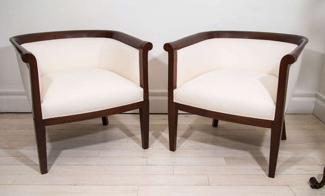 Pair of mahogany curved back upholstered chairs with tapered legs.