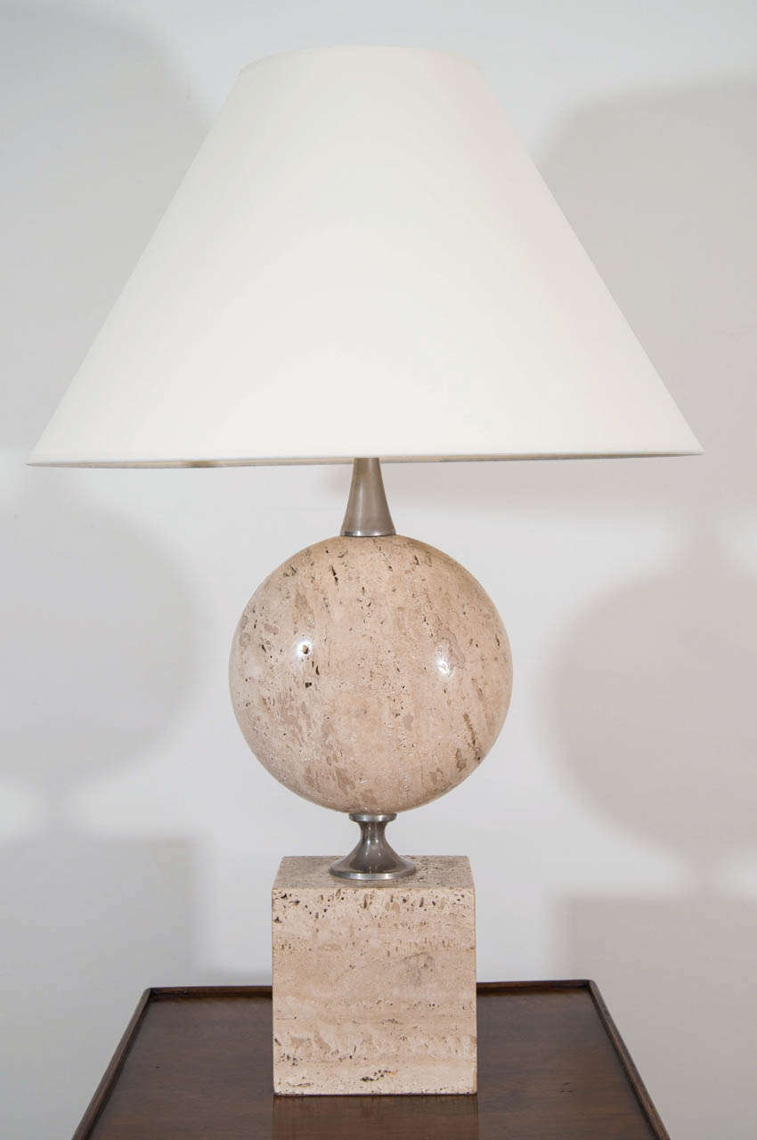 Large travertine and metal table lamp with rectangular and flattened circular sections joined by silvered metal pieces.